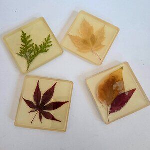 Set of 4 vintage handmade Lucite coasters with dry pressed leaves.